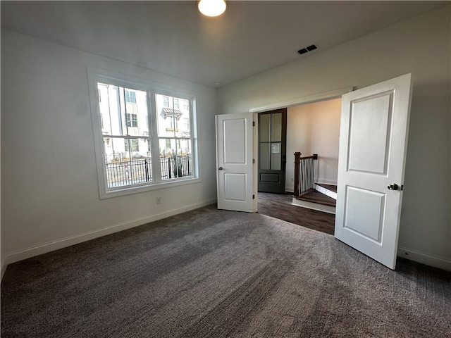508 Healy Dr Unit 70, Cumming, GA 30040 - unfurnished bedroom featuring carpet floors, baseboards, and a closet