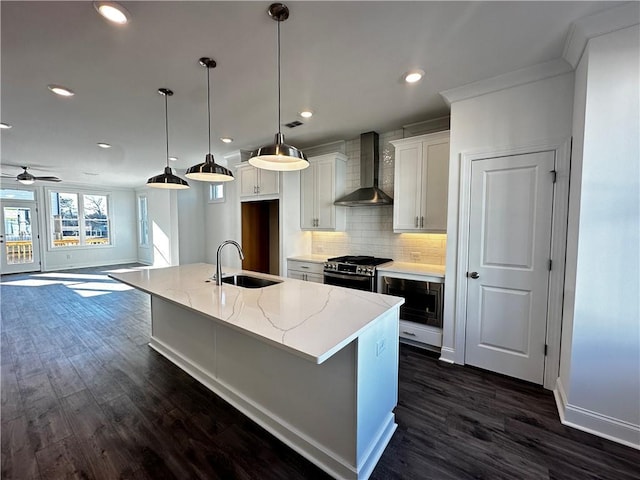 508 Healy Dr Unit 70, Cumming, GA 30040 - kitchen featuring wall chimney range hood, a sink, stainless steel range with gas stovetop, dark wood-type flooring, and tasteful backsplash