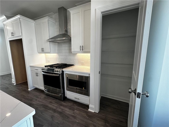 508 Healy Dr Unit 70, Cumming, GA 30040 - kitchen with wall chimney exhaust hood, appliances with stainless steel finishes, backsplash, and white cabinets