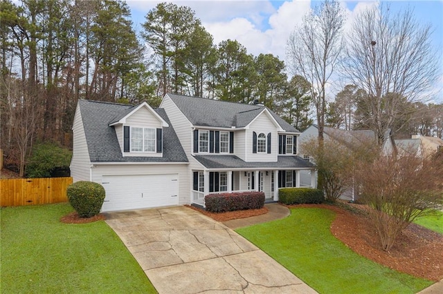 view of front facade with a front yard and a garage