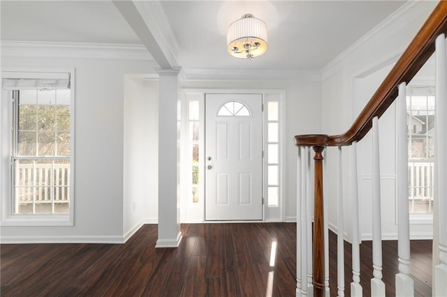 entrance foyer with dark hardwood / wood-style floors and crown molding