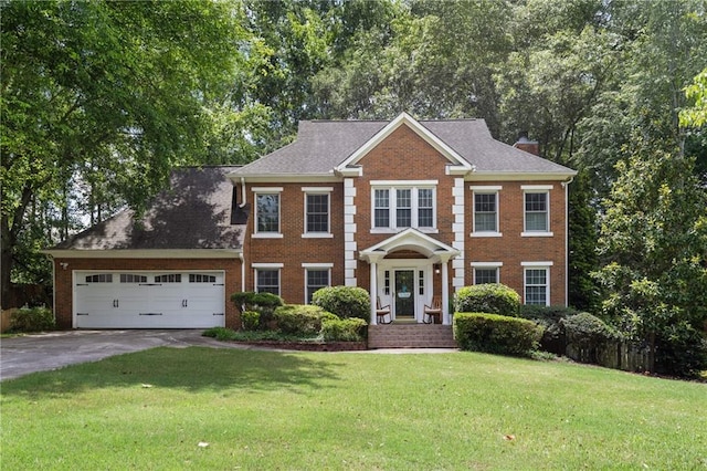 4648 Equestrian Way, Atlanta, GA 30338 - georgian-style home featuring brick siding, asphalt driveway, an attached garage, and a front yard