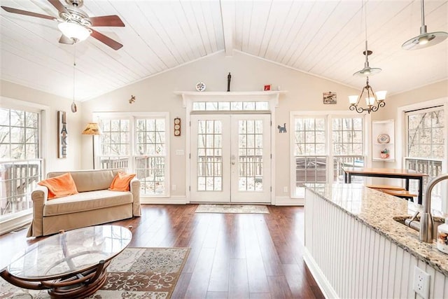 interior space featuring dark wood-style floors, french doors, a healthy amount of sunlight, and vaulted ceiling with beams