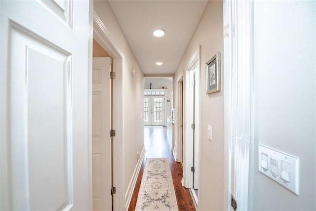 corridor featuring baseboards, dark wood-type flooring, and recessed lighting