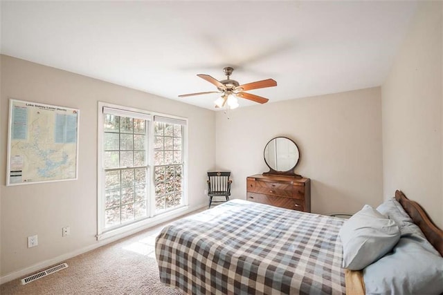 carpeted bedroom featuring visible vents, ceiling fan, and baseboards