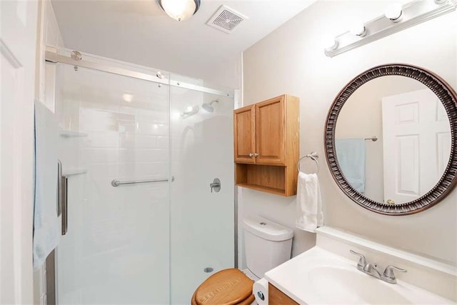 full bath featuring toilet, a shower stall, visible vents, and vanity