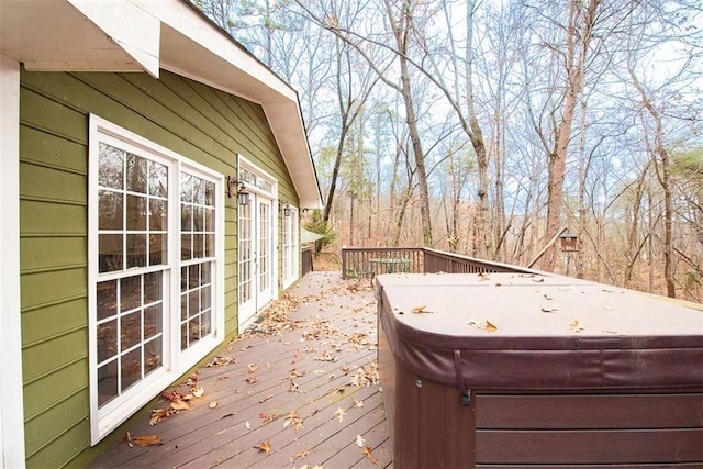 wooden deck featuring a hot tub