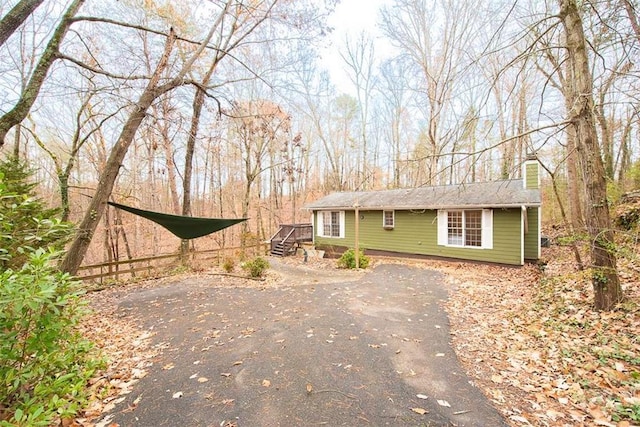 view of front of house featuring aphalt driveway and a chimney