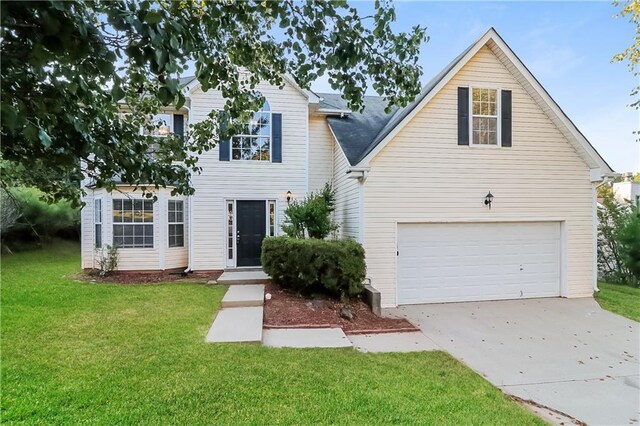 view of front of property with a garage and a front lawn