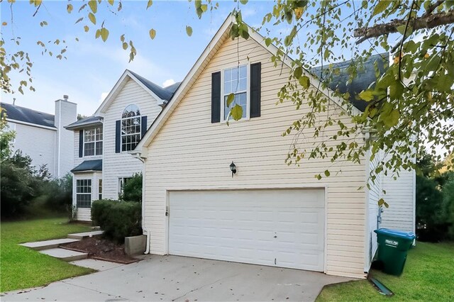 exterior space with a front yard and a garage