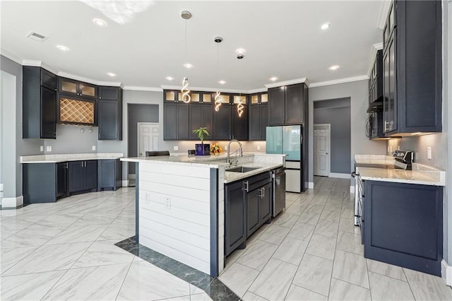 kitchen featuring visible vents, ornamental molding, a sink, appliances with stainless steel finishes, and glass insert cabinets