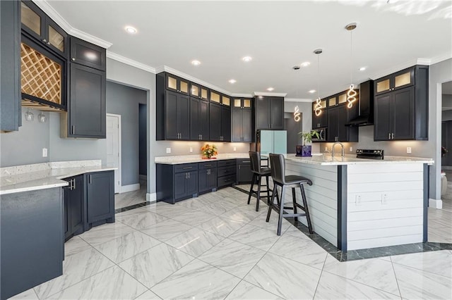 kitchen featuring ornamental molding, recessed lighting, a kitchen breakfast bar, hanging light fixtures, and wall chimney exhaust hood