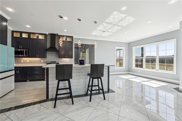 kitchen featuring marble finish floor, stainless steel microwave, wall chimney exhaust hood, crown molding, and glass insert cabinets