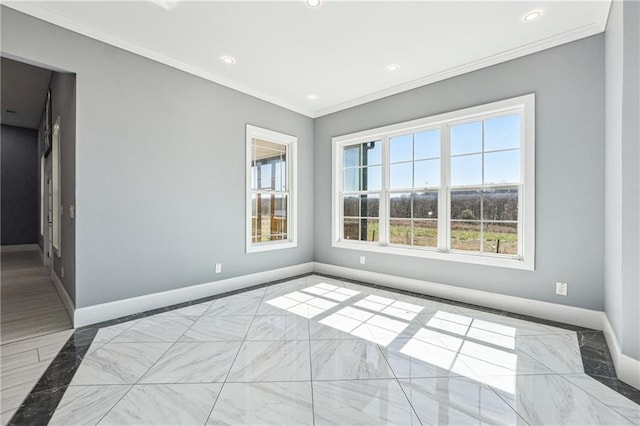 spare room featuring crown molding, baseboards, and marble finish floor