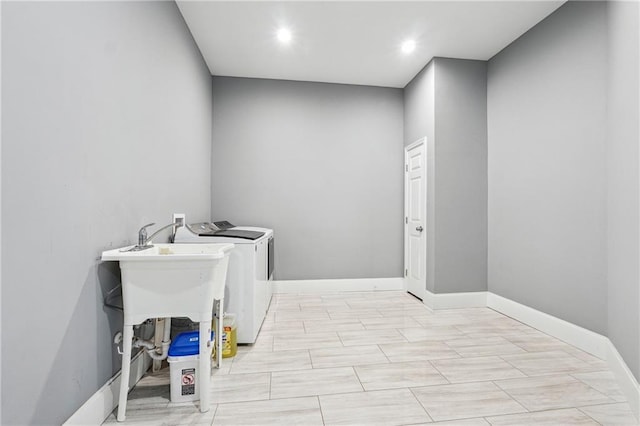 washroom with recessed lighting, baseboards, laundry area, and washing machine and clothes dryer