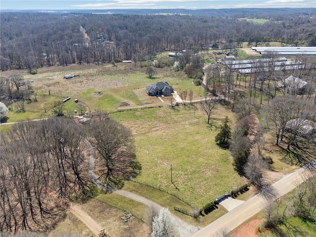 birds eye view of property with a rural view and a wooded view