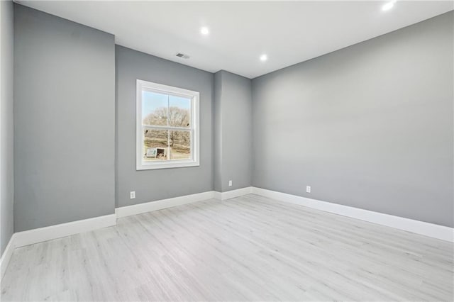 empty room featuring recessed lighting, visible vents, baseboards, and light wood finished floors