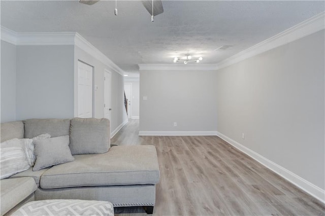 living room featuring crown molding, a textured ceiling, ceiling fan, and light hardwood / wood-style flooring