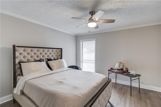 bedroom featuring ceiling fan, ornamental molding, hardwood / wood-style floors, and a textured ceiling