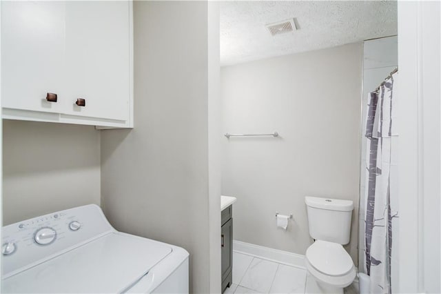 interior space with washer / clothes dryer and a textured ceiling