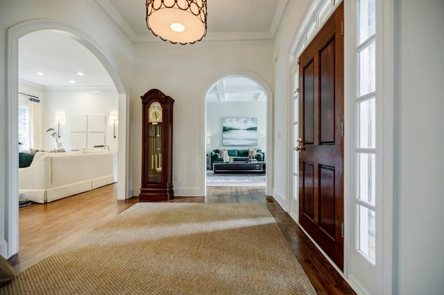 663 Clifton Rd NE, Atlanta, GA 30307 - entryway with plenty of natural light, dark wood-type flooring, crown molding, arched walkways, and baseboards