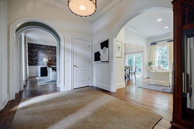 663 Clifton Rd NE, Atlanta, GA 30307 - foyer with arched walkways, wood finished floors, crown molding, baseboards, and wallpapered walls
