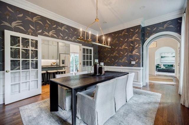 663 Clifton Rd NE, Atlanta, GA 30307 - kitchen with wallpapered walls, a wainscoted wall, ornamental molding, white cabinets, and wood finished floors