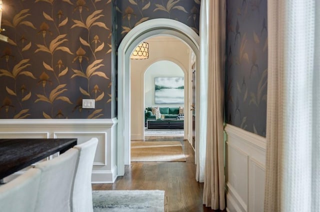 663 Clifton Rd NE, Atlanta, GA 30307 - hall featuring wallpapered walls, wainscoting, wood finished floors, and arched walkways