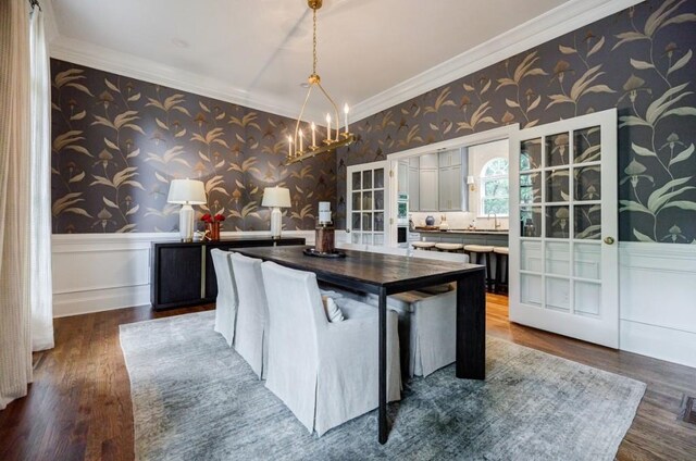 663 Clifton Rd NE, Atlanta, GA 30307 - kitchen with wallpapered walls, wainscoting, crown molding, wood finished floors, and a chandelier