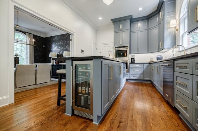 663 Clifton Rd NE, Atlanta, GA 30307 - kitchen with gray cabinetry, ornamental molding, appliances with stainless steel finishes, plenty of natural light, and recessed lighting