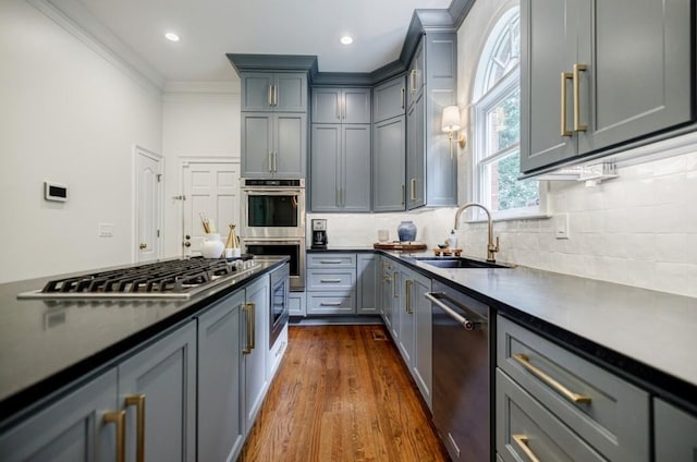 663 Clifton Rd NE, Atlanta, GA 30307 - kitchen featuring a sink, appliances with stainless steel finishes, gray cabinetry, dark countertops, and decorative backsplash