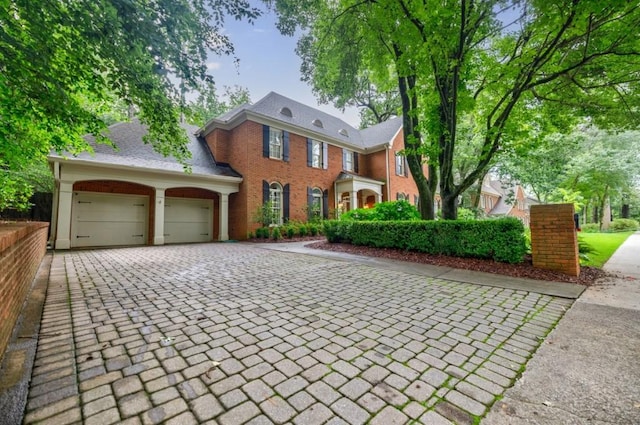 663 Clifton Rd NE, Atlanta, GA 30307 - colonial house with decorative driveway and an attached garage