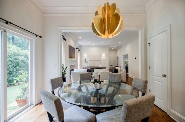 663 Clifton Rd NE, Atlanta, GA 30307 - dining area featuring ornamental molding, wood finished floors, a fireplace, and baseboards