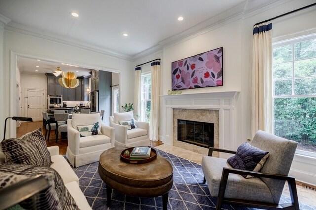 663 Clifton Rd NE, Atlanta, GA 30307 - living area featuring healthy amount of natural light, recessed lighting, ornamental molding, a tiled fireplace, and dark wood-style floors