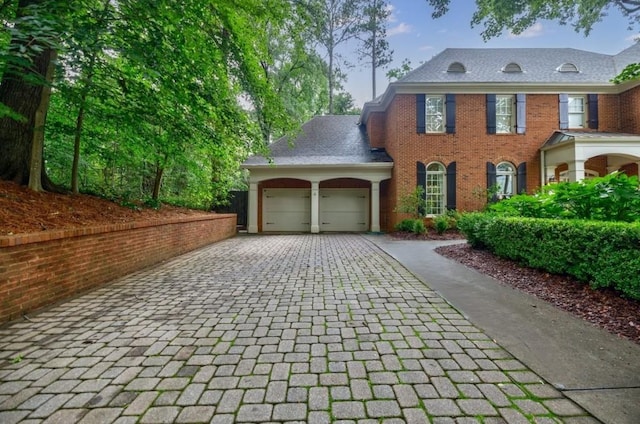 663 Clifton Rd NE, Atlanta, GA 30307 - view of front facade with decorative driveway, a garage, and brick siding