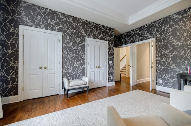 663 Clifton Rd NE, Atlanta, GA 30307 - bedroom featuring multiple closets, wood finished floors, ornamental molding, wallpapered walls, and baseboards