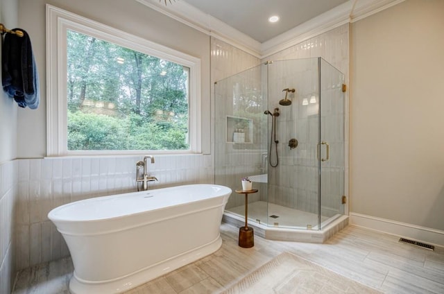 663 Clifton Rd NE, Atlanta, GA 30307 - bathroom featuring a freestanding tub, a stall shower, healthy amount of natural light, ornamental molding, and recessed lighting