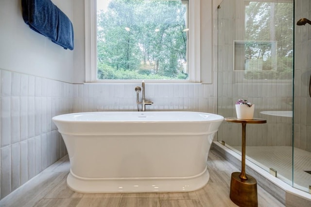 663 Clifton Rd NE, Atlanta, GA 30307 - bathroom featuring tile walls, a freestanding bath, and a tile shower