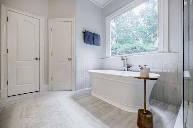 663 Clifton Rd NE, Atlanta, GA 30307 - full bath with a freestanding tub, crown molding, and wainscoting