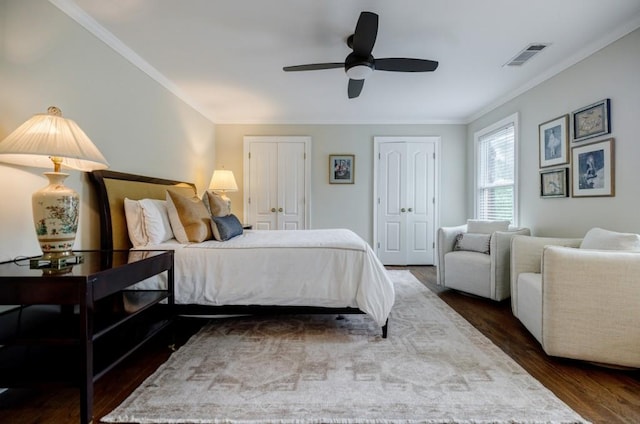 663 Clifton Rd NE, Atlanta, GA 30307 - bedroom featuring dark wood-style flooring, multiple closets, ornamental molding, and a ceiling fan