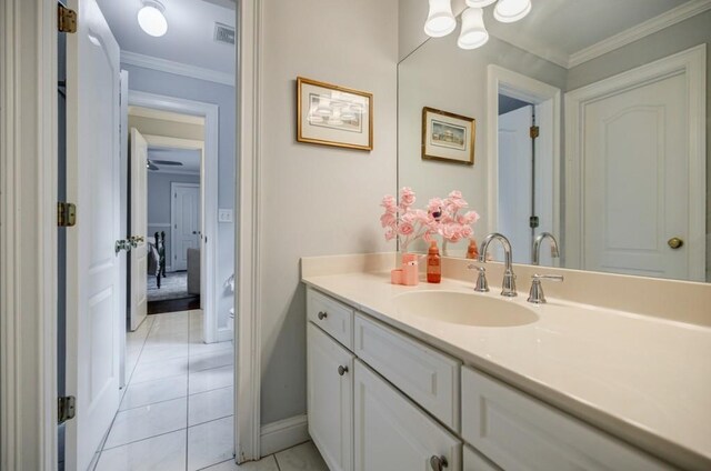663 Clifton Rd NE, Atlanta, GA 30307 - bathroom with vanity, tile patterned floors, crown molding, and baseboards