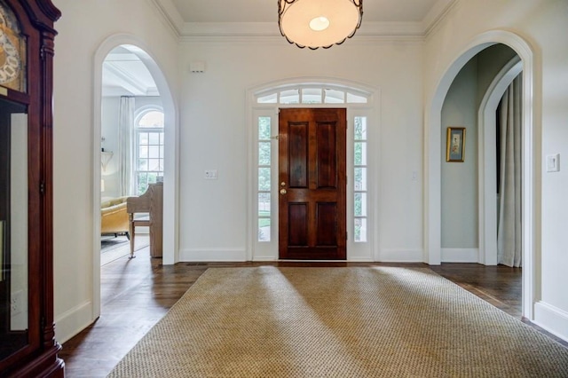 663 Clifton Rd NE, Atlanta, GA 30307 - entryway featuring dark wood finished floors, arched walkways, ornamental molding, and baseboards