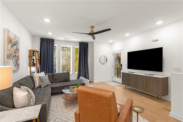 living room with ceiling fan and light hardwood / wood-style floors