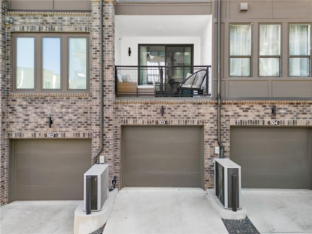 interior space with a balcony, ac unit, and a garage