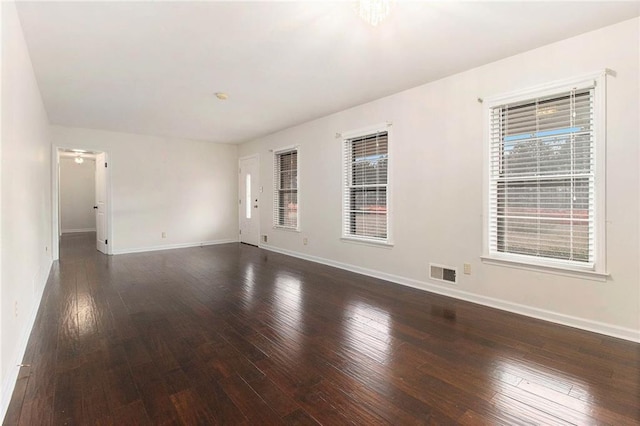 unfurnished room with dark hardwood / wood-style flooring