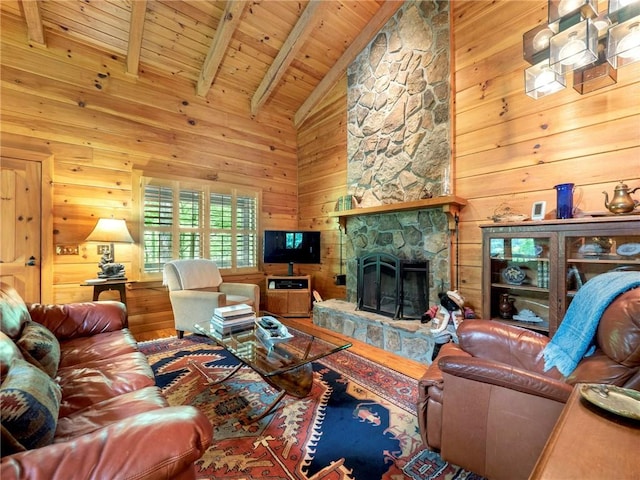 living room with beamed ceiling, wooden ceiling, wood walls, high vaulted ceiling, and a stone fireplace