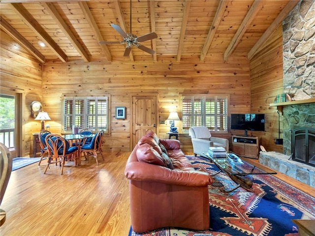 living room featuring wooden ceiling, a healthy amount of sunlight, and light hardwood / wood-style flooring