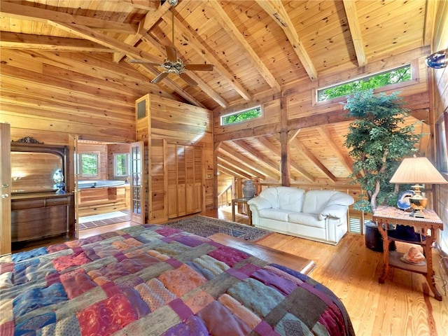 bedroom with wood walls, multiple windows, and wooden ceiling