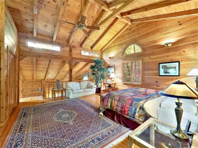 bedroom featuring light hardwood / wood-style floors, wood walls, wooden ceiling, and vaulted ceiling with beams