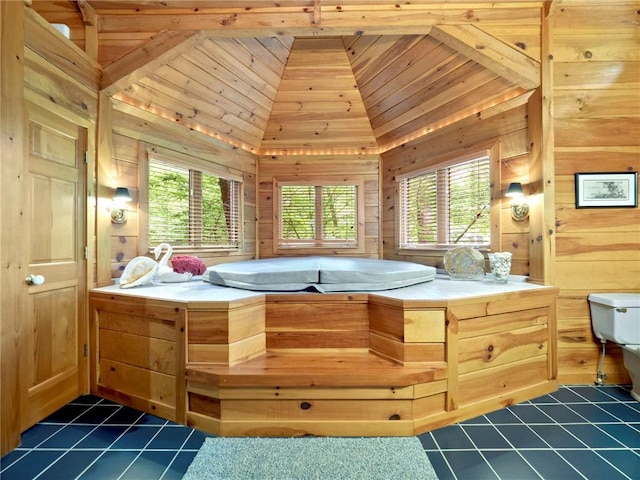 bathroom featuring a wealth of natural light, wood ceiling, wooden walls, and vaulted ceiling